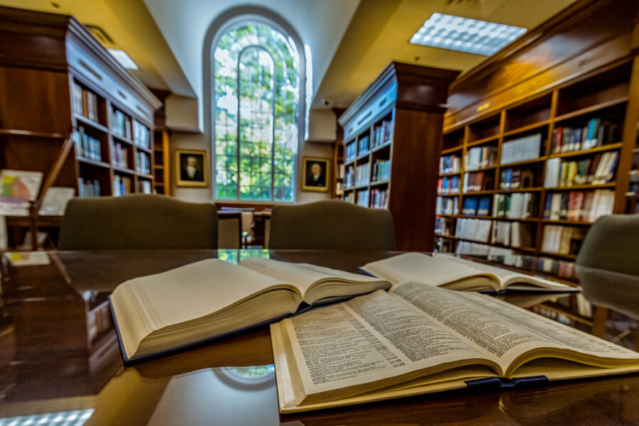 open books in Heritage Center with large window view in the background