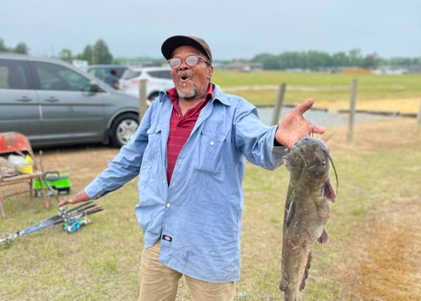 Senior excitedly shows off his catch from the Fishing Rodeo