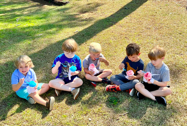 Five Children Sit in a Park Eating Snow Cones Back to School