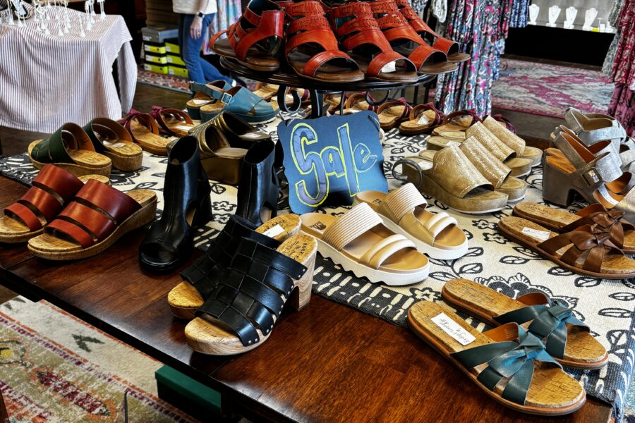 A spread of fashionable shoes on top of a table at Emma Laura