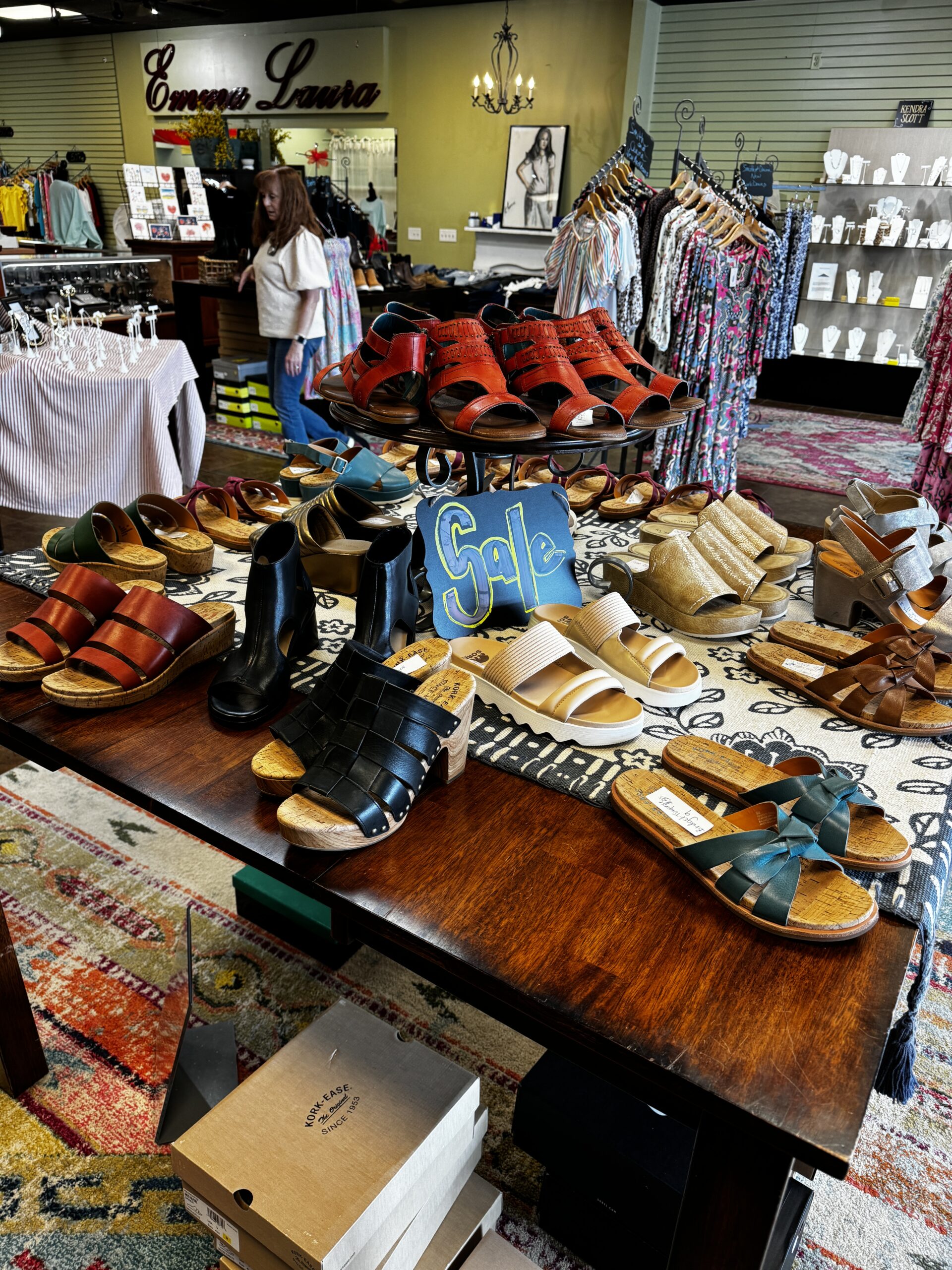 A spread of fashionable shoes on top of a table at Emma Laura