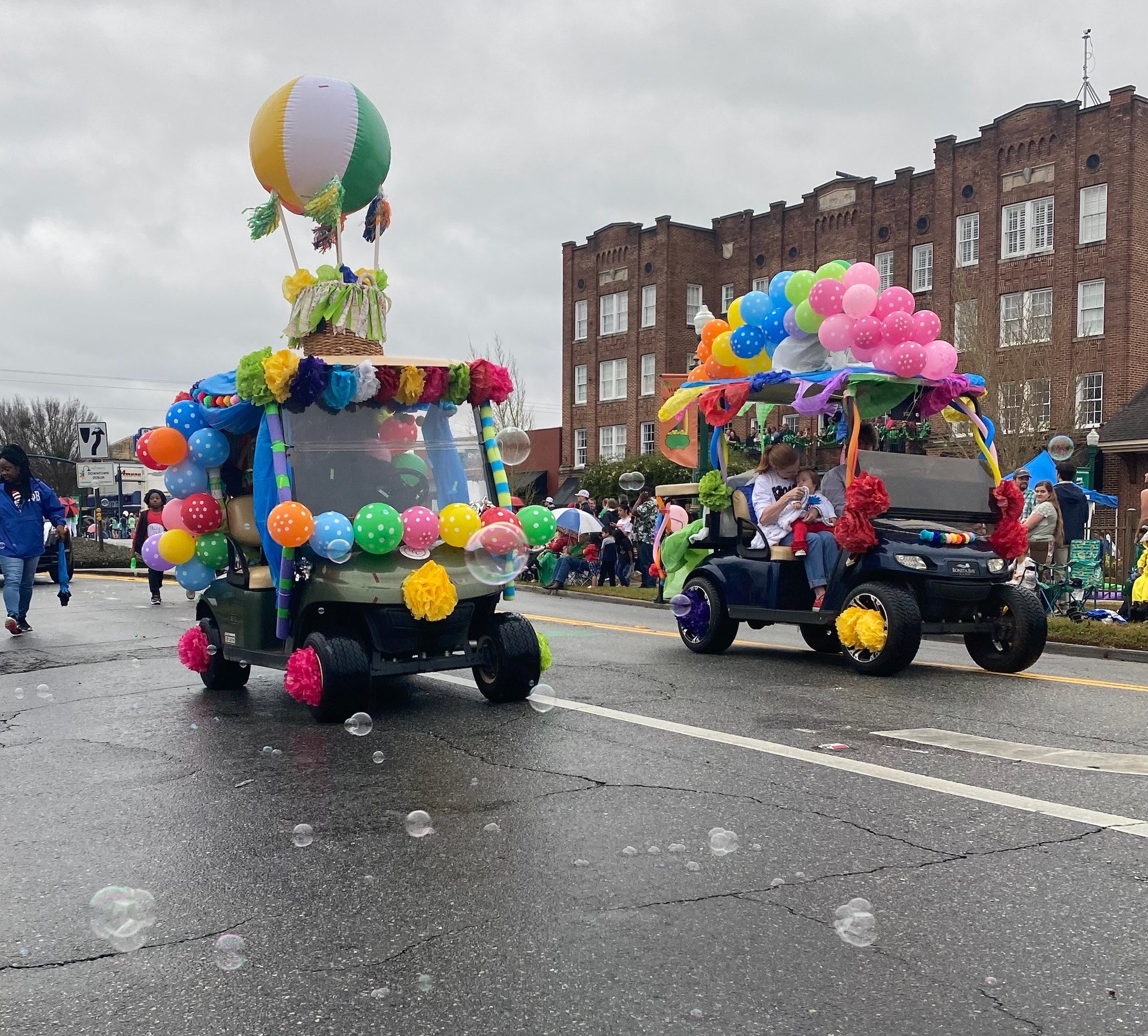 Golf Carts Decked out with Rainbow Balloons take to the Streets on Super Saturday