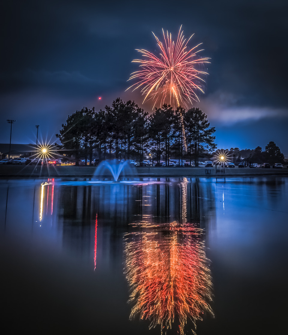 fireworks reflecting in a pond at Southern Pines celebrating Independence Day.