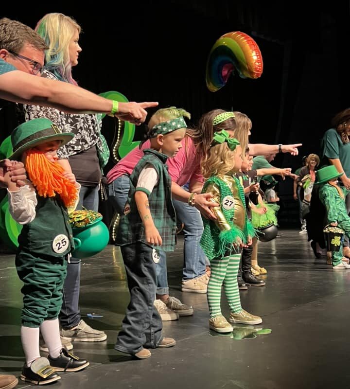Costumed contestants on stage participating in the Littlest leprechaun Contest.