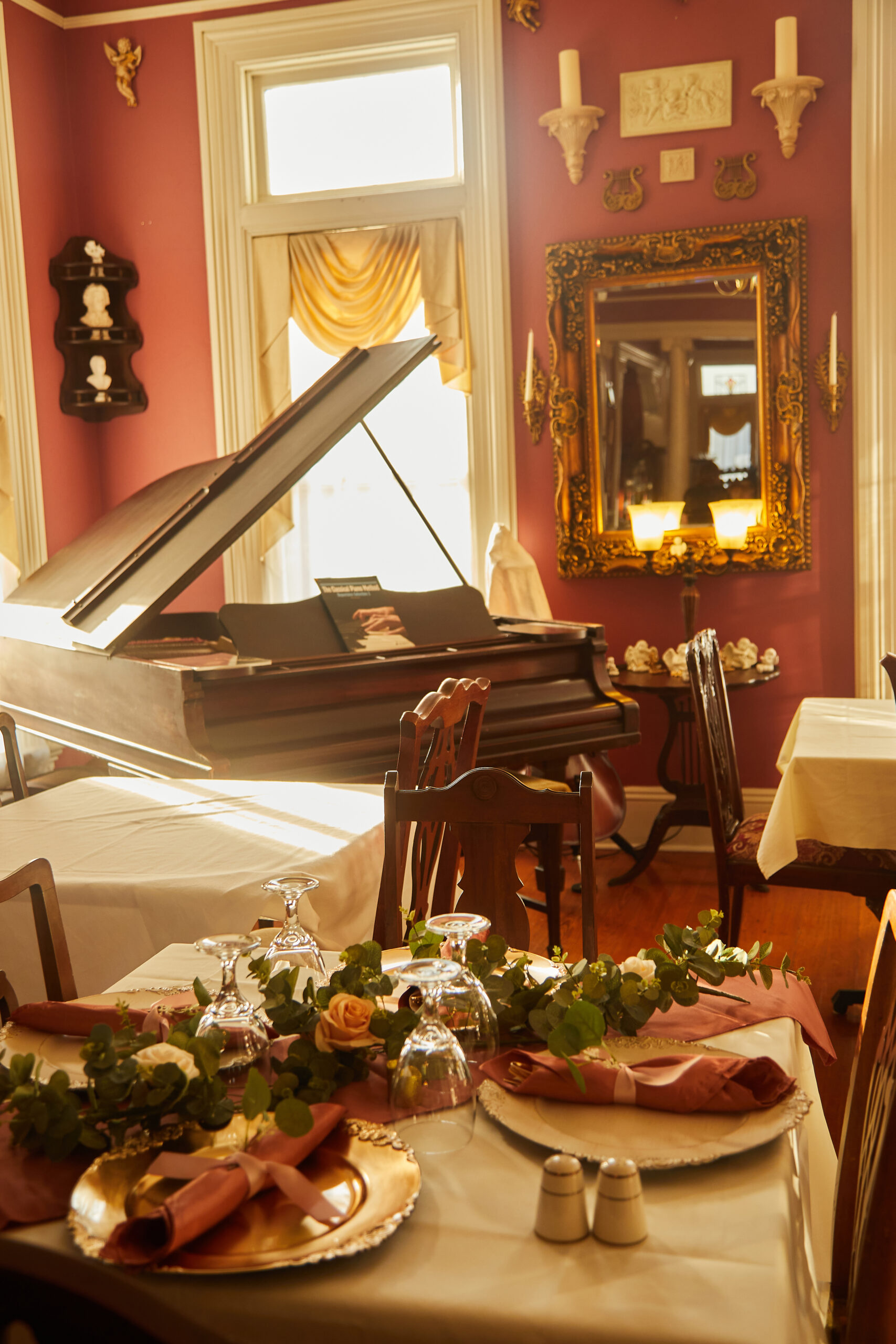 elegant table setting and grand piano in dining area at Page House Bed & Breakfast.