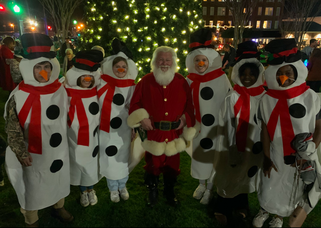 Santa gathers around the Christmas tree with a melt of snowmen at Jingle and Mingle in Dublin GA