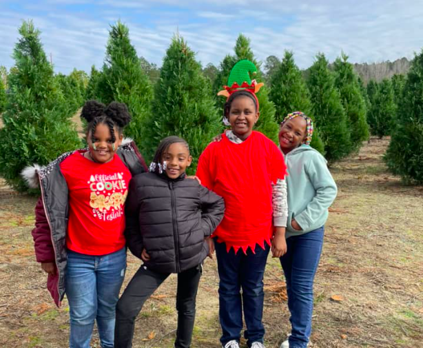 Four children enjoying a trip Southern Cypress Christmas Tree Farm|Market on Madison||Southern Cypress|Southern Cypress|The Market|christmas tree|Kid with Saw Contemplates Cutting Christmas Tree|