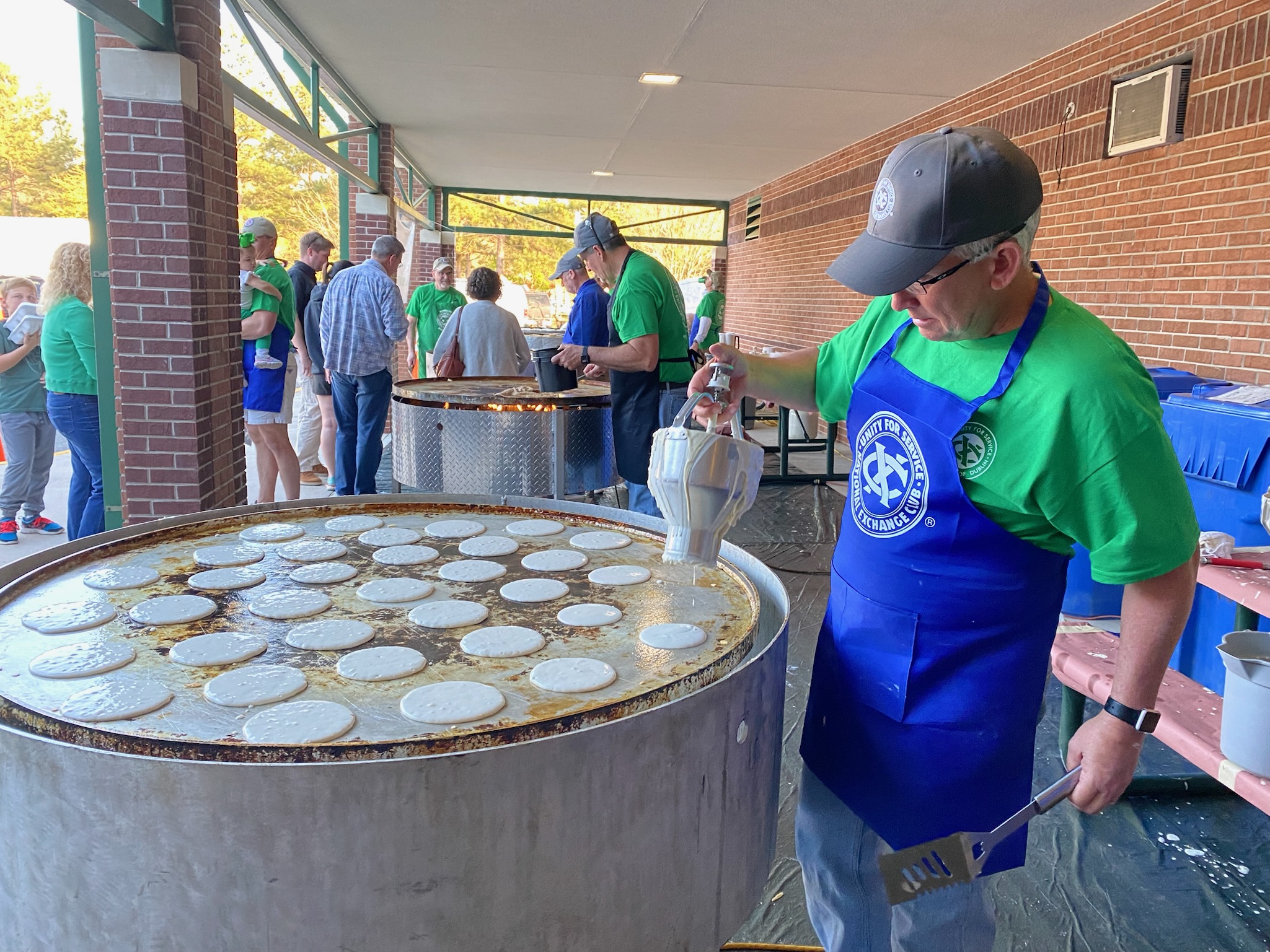 Pancakes being cooked on a giant griddle during the St. Patrick's Pancake Supper.