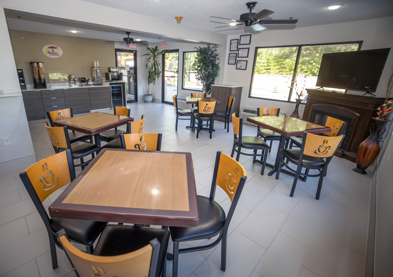 Super 8 dining area with tables and chairs.