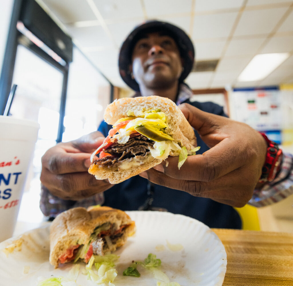 Patron at Brian's Subs shows off the meaty layers of his sub sandwich.