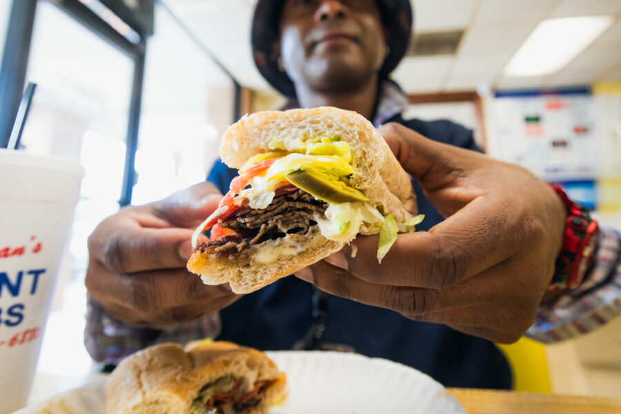 Patron at Brian's Subs shows off the meaty layers of his sub sandwich.