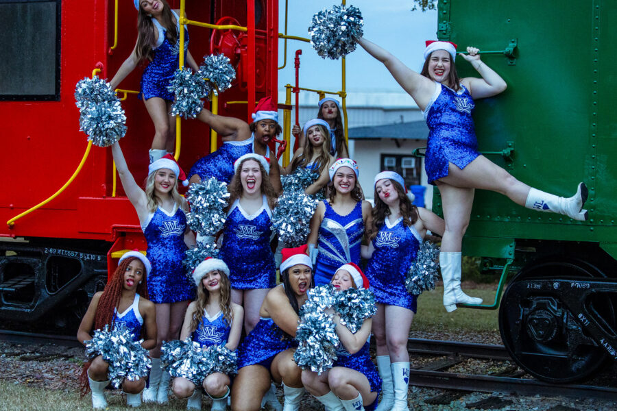 Cheerleaders in Santa hats posing on a caboose and train car in Downtown Dulblin, a few blocks from Theatre Dublin where the movie Polar Express is watched each holiday season.