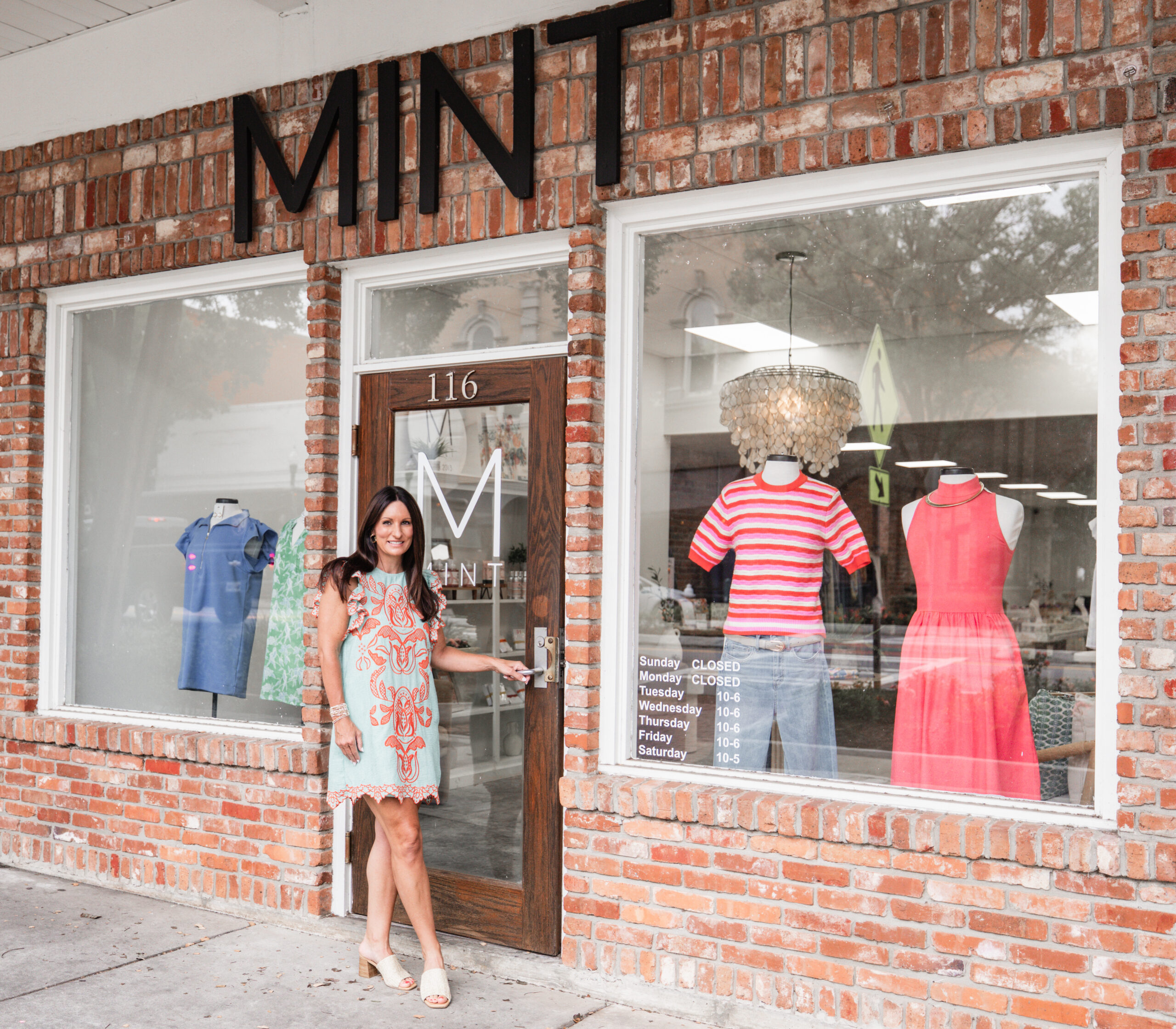 Mint Boutique owner Laura standing at the door of the Mint storefront.