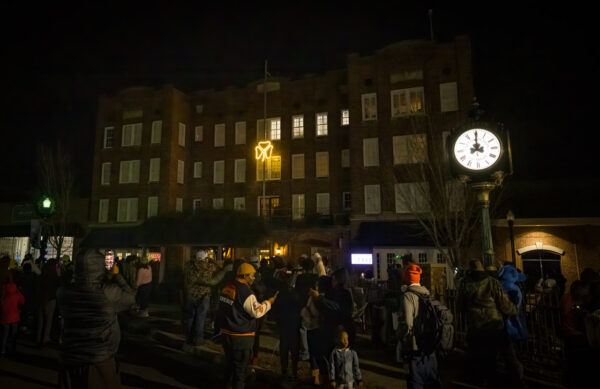 Glowing shamrock dropping from the top of the historic Fred Roberts building during NYE Shamrock Drop in Downtown Dublin GA.