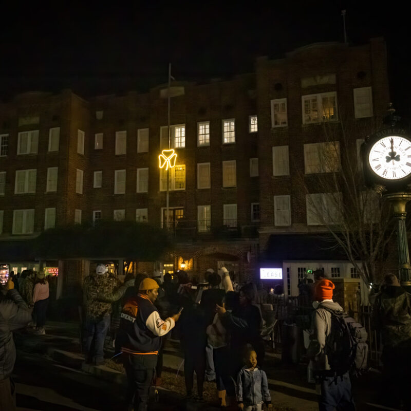 Glowing shamrock dropping from the top of the historic Fred Roberts building during NYE Shamrock Drop in Downtown Dublin GA.