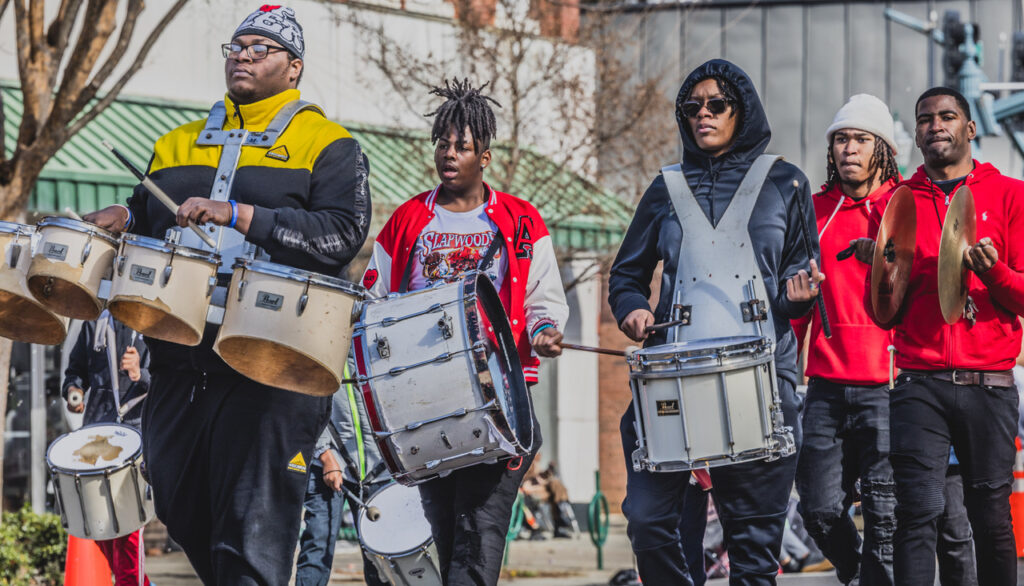 Men marching with drums during the MLK Parade.
