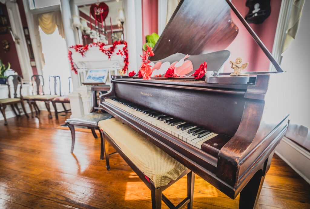 Piano at the Page House decorated with Valentine's Day decor - Flirty and fun events