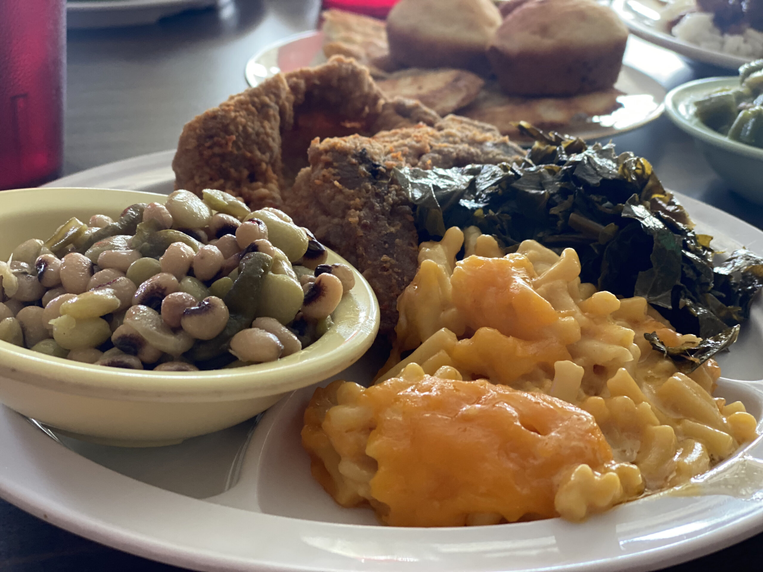 Plate of comfort food at Miller's Soul Food heaped with peas, Mac and cheese and fried chicken.
