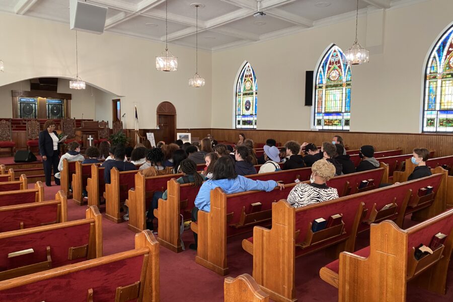 People sitting in the pews inside First African Baptist Church where the Oratorical Speech Contest takes place.