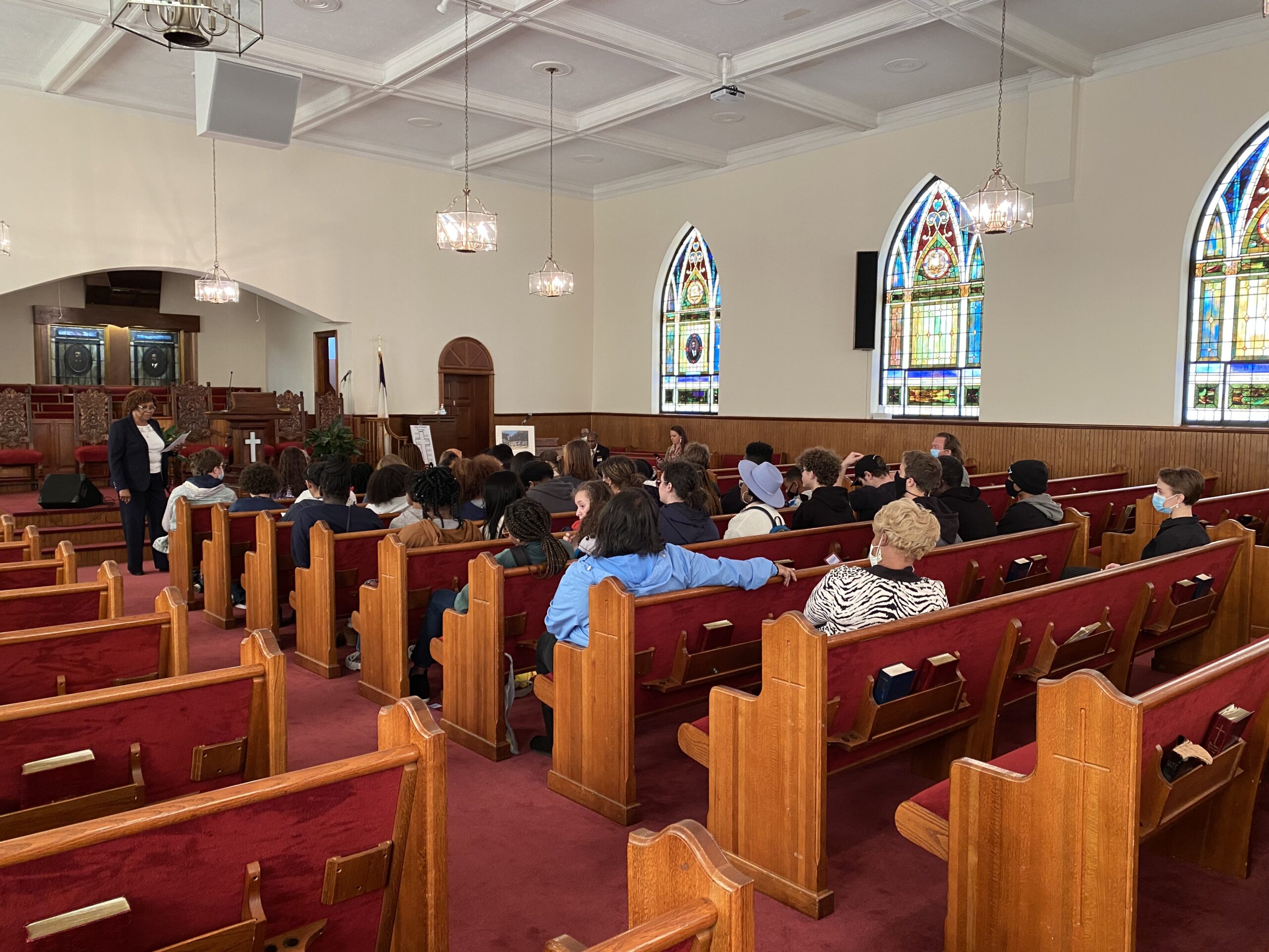 People sitting in the pews inside First African Baptist Church where the Oratorical Speech Contest takes place.