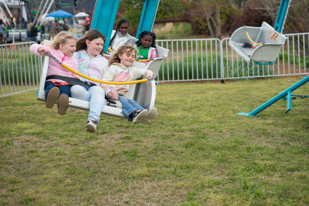 Children enjoying spinning on a festival ride that will be at Spring Fest!