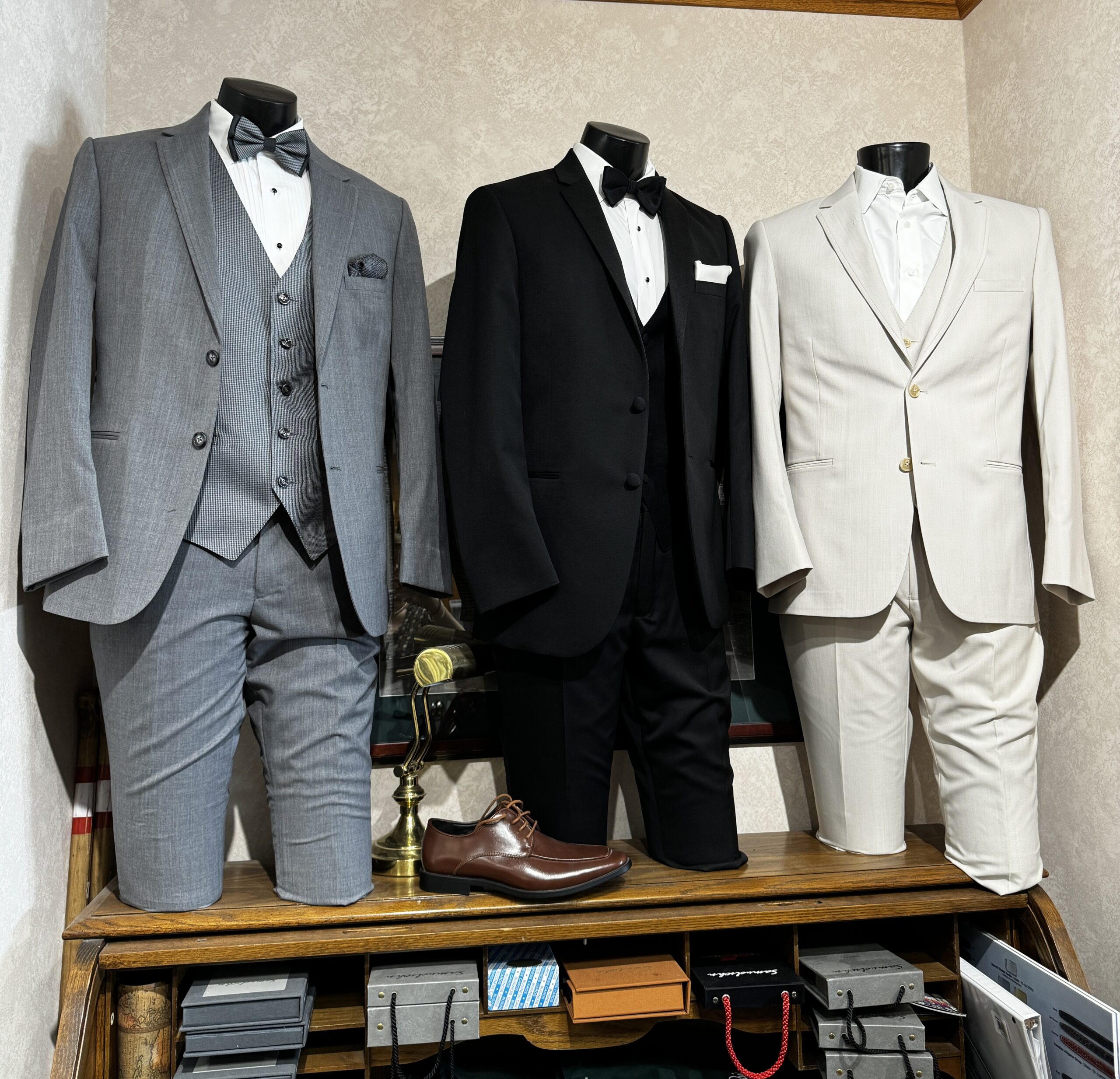 Tuxedos on mannequins on the wall