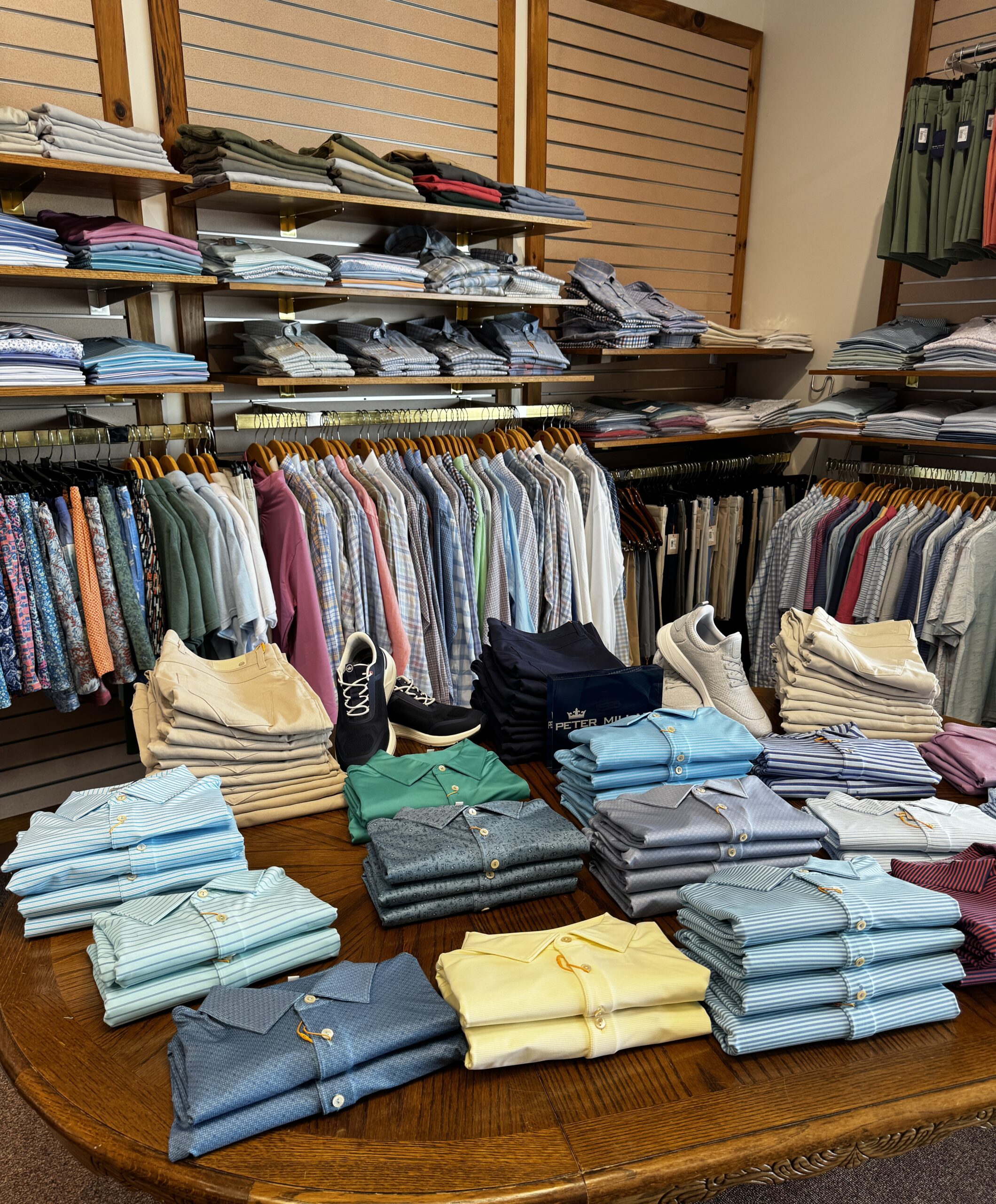 Peter Millar shirts line the walls and table