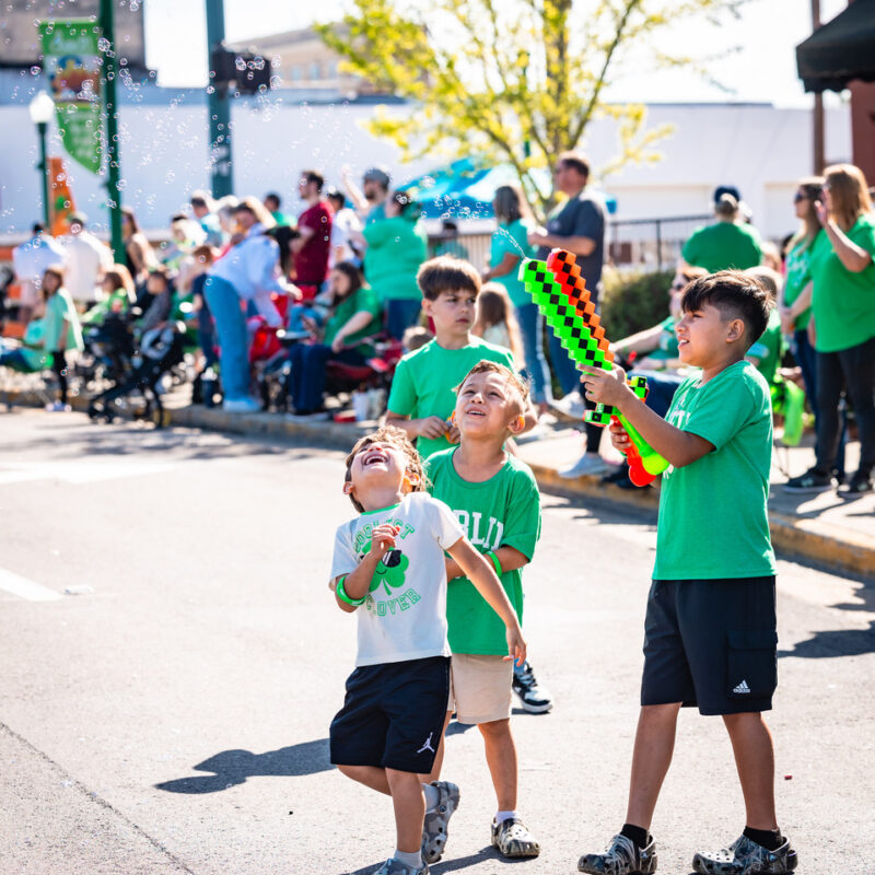 Children playing with bubbles during the St. Patrick's Festival parade.