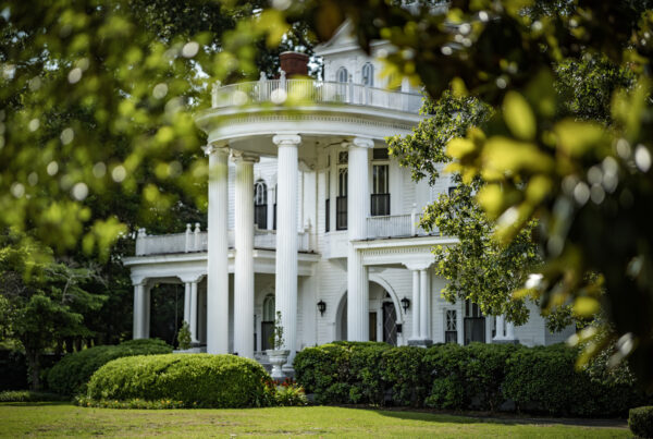 View of the Lovett House through the trees on the Historic Bellevue Avenue Tour