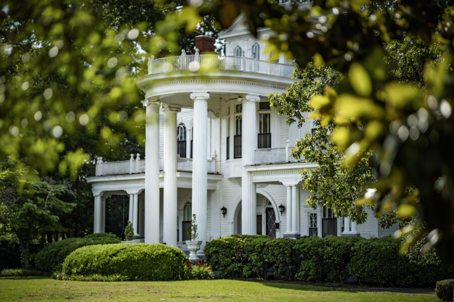 View of the Lovett House through the trees on the Historic Bellevue Avenue Tour