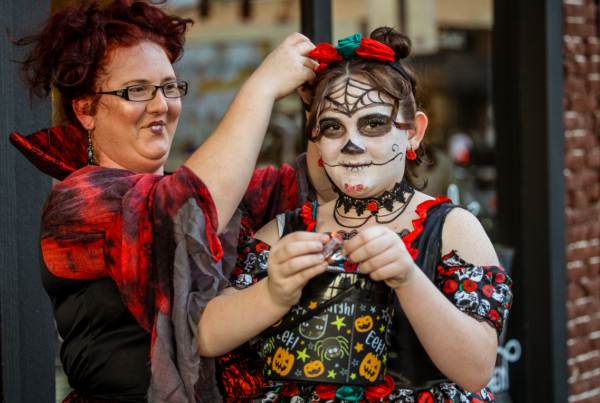 Mother prepares her daughter to go trick or treat in downtown Dublin