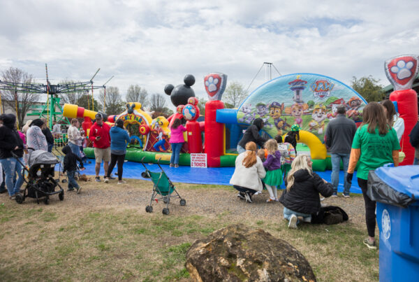 Families gathered around a kid's bouncy house during the St. Patrick's Festival. Tourism grant funding provides marketing support for the festival.