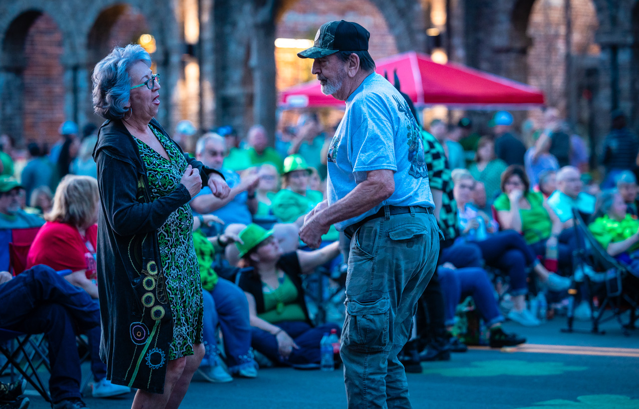 Older couple dances in front of the crowd at Music & Munchies