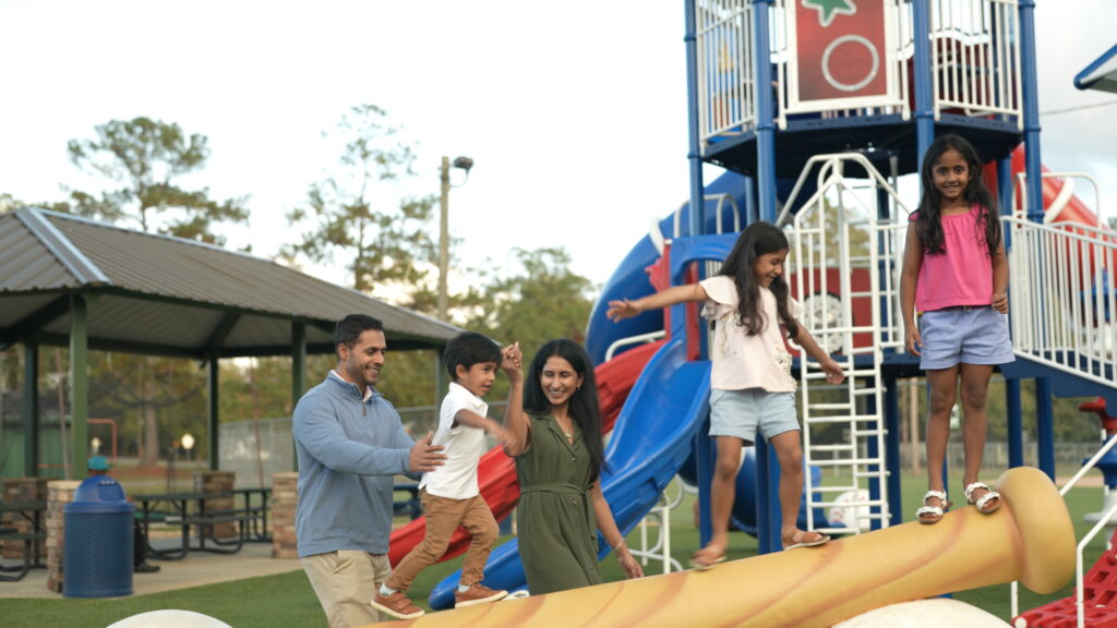 Family playing at the park in Dublin during their perfect weekend getaway.