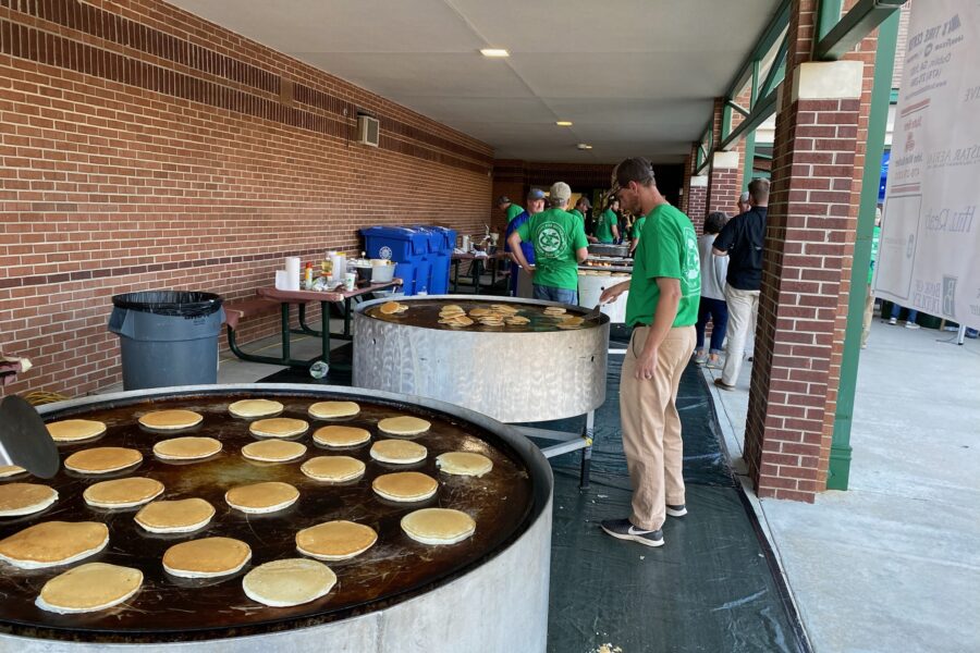 A volunteer keeping an eye on a huge griddle of pancakes during the St. Patrick's Pancake Supper.