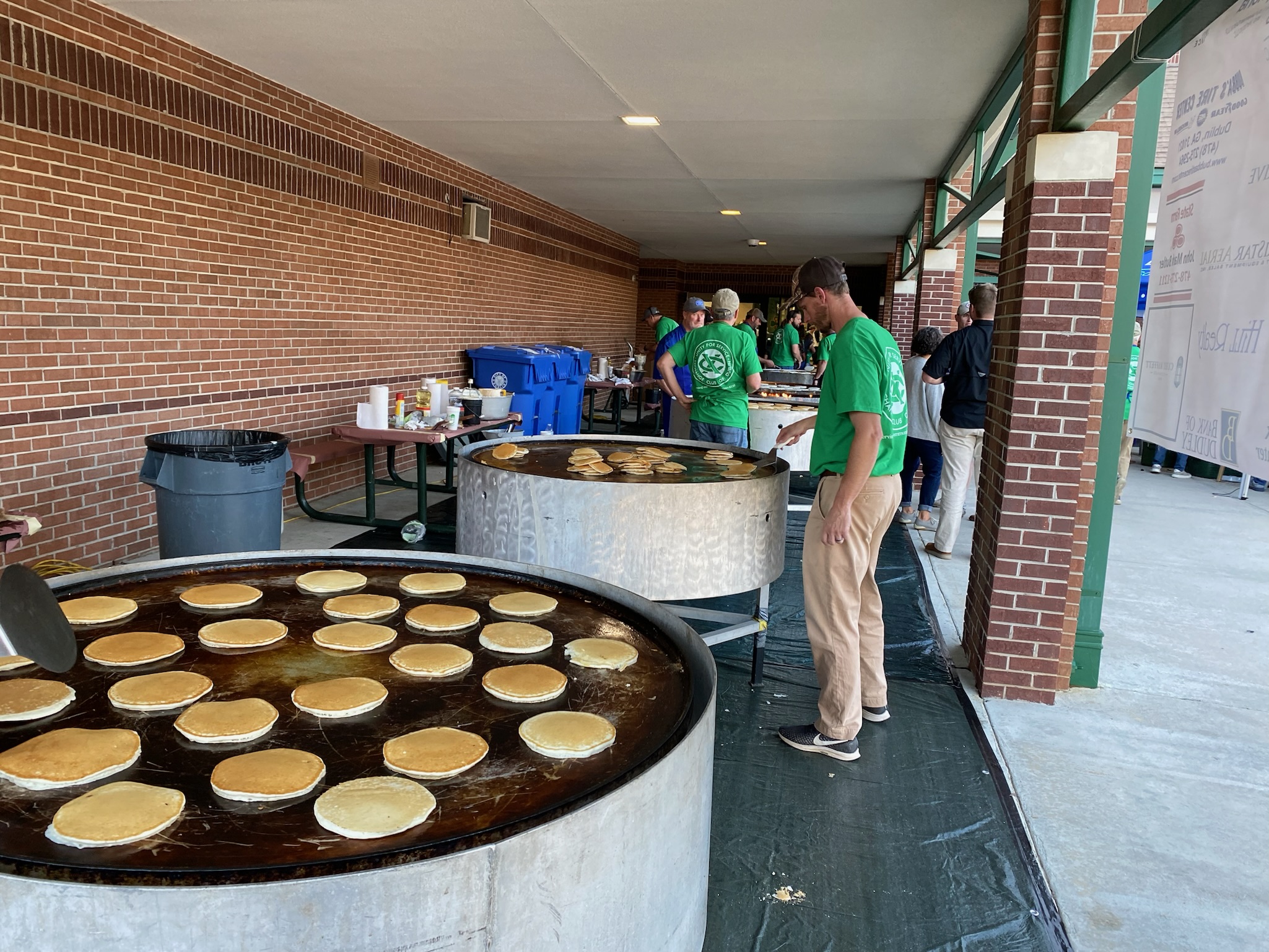 A volunteer keeping an eye on a huge griddle of pancakes during the St. Patrick's Pancake Supper.