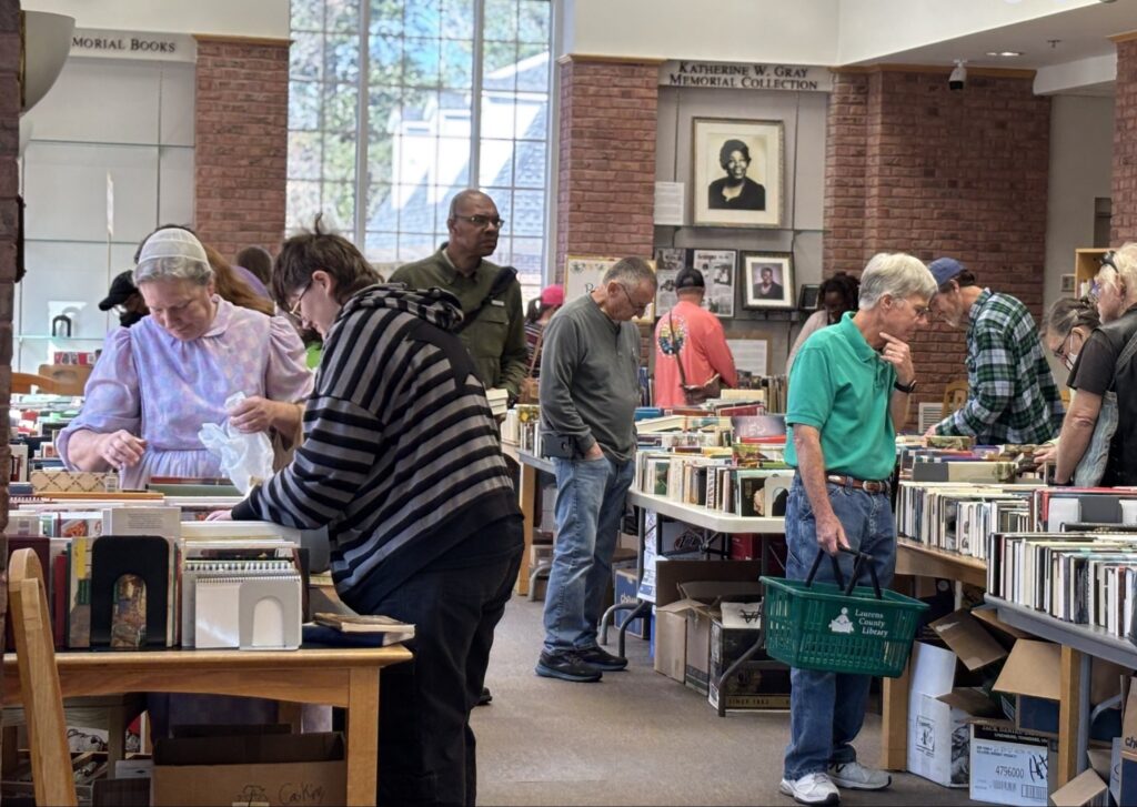 Library patrons peruse the tables at the St. Patrick's Book Sale