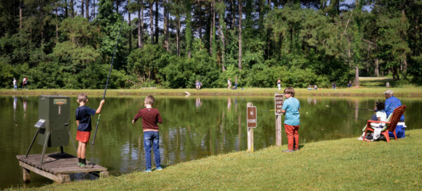 Little kids during free fishing day at Hugh Gillis PFA
