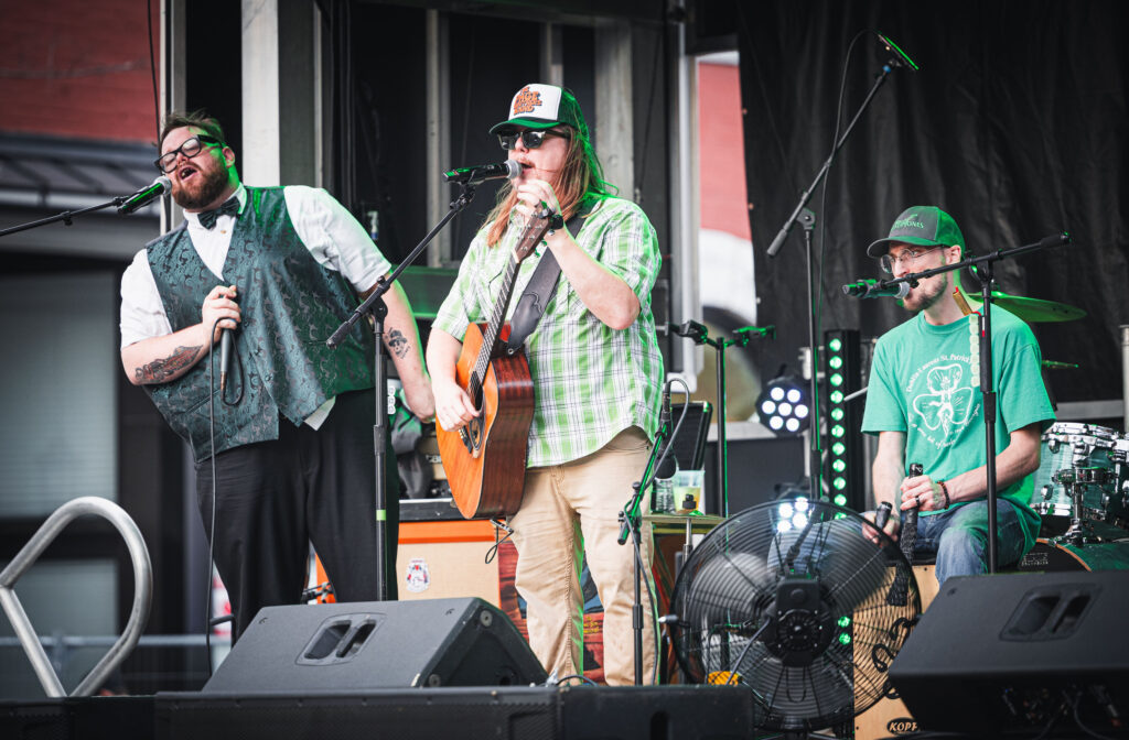 2025's opening band sings on the stage at Music & Munchies