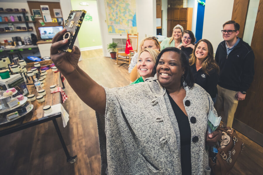 Woman takes a selfie with friends at the Dublin Visitors Center during Travel and Tourism Week
