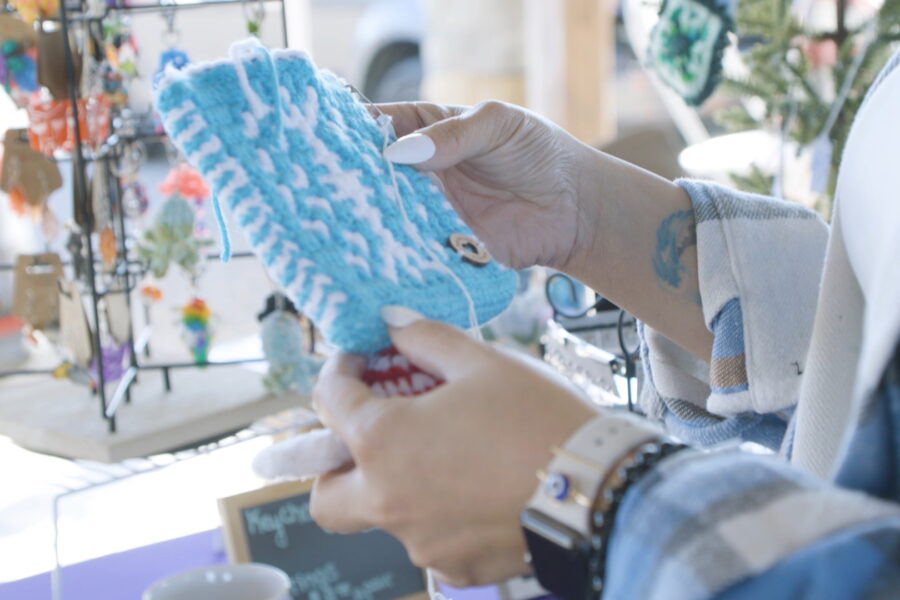 Customer holding a handmade pot holder being sold by a vendor at one of Dublin's many markets.