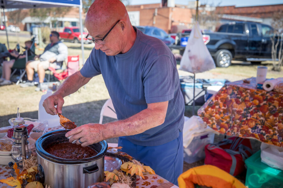 Man serving up his chili at the Chili Cook Off and Fall Festival