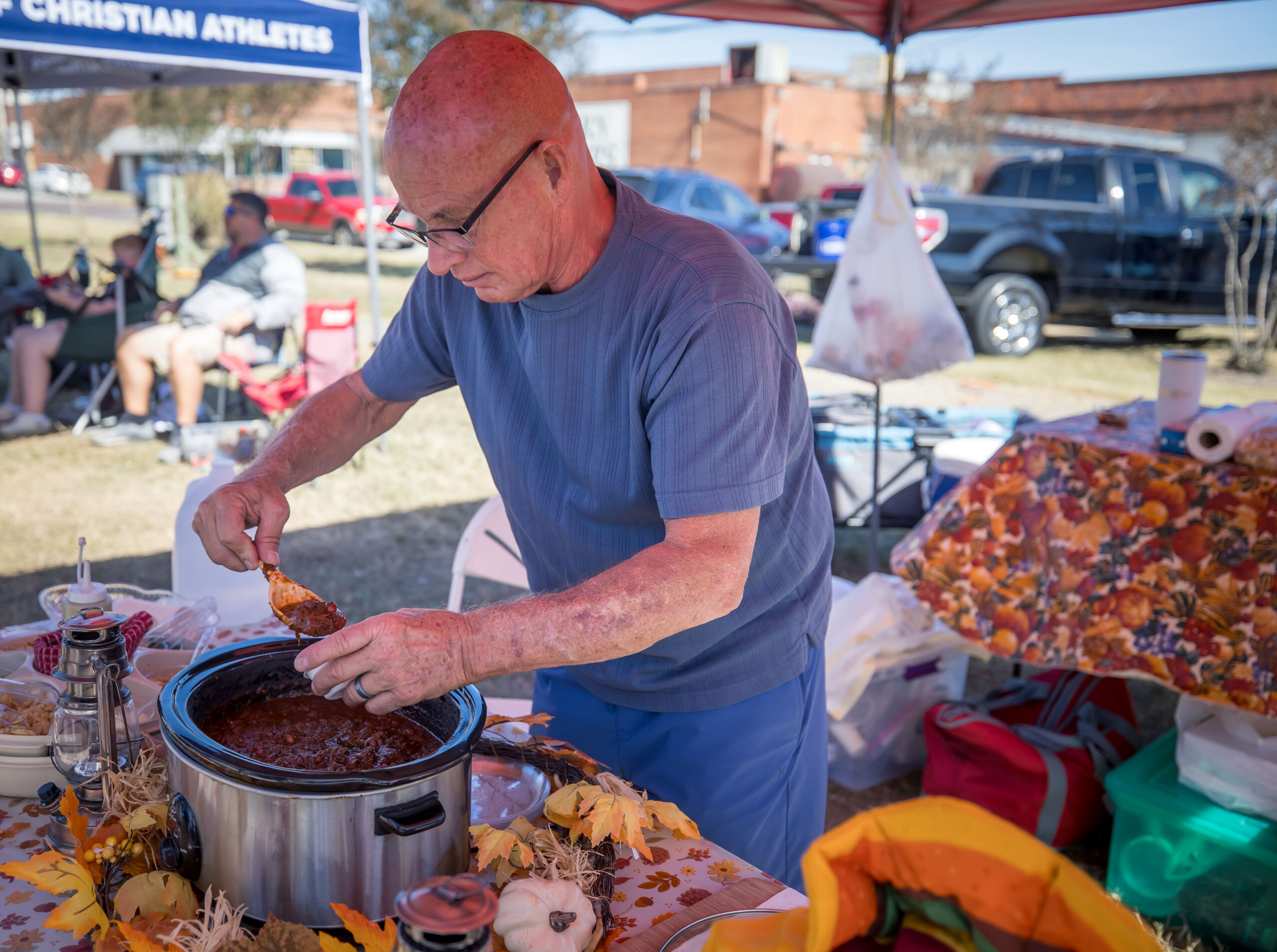 Man serving up his chili at the Chili Cook Off and Fall Festival