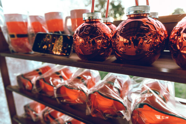 Bright red cups shaped like ornaments are an example of what can be found at the Merry Market!