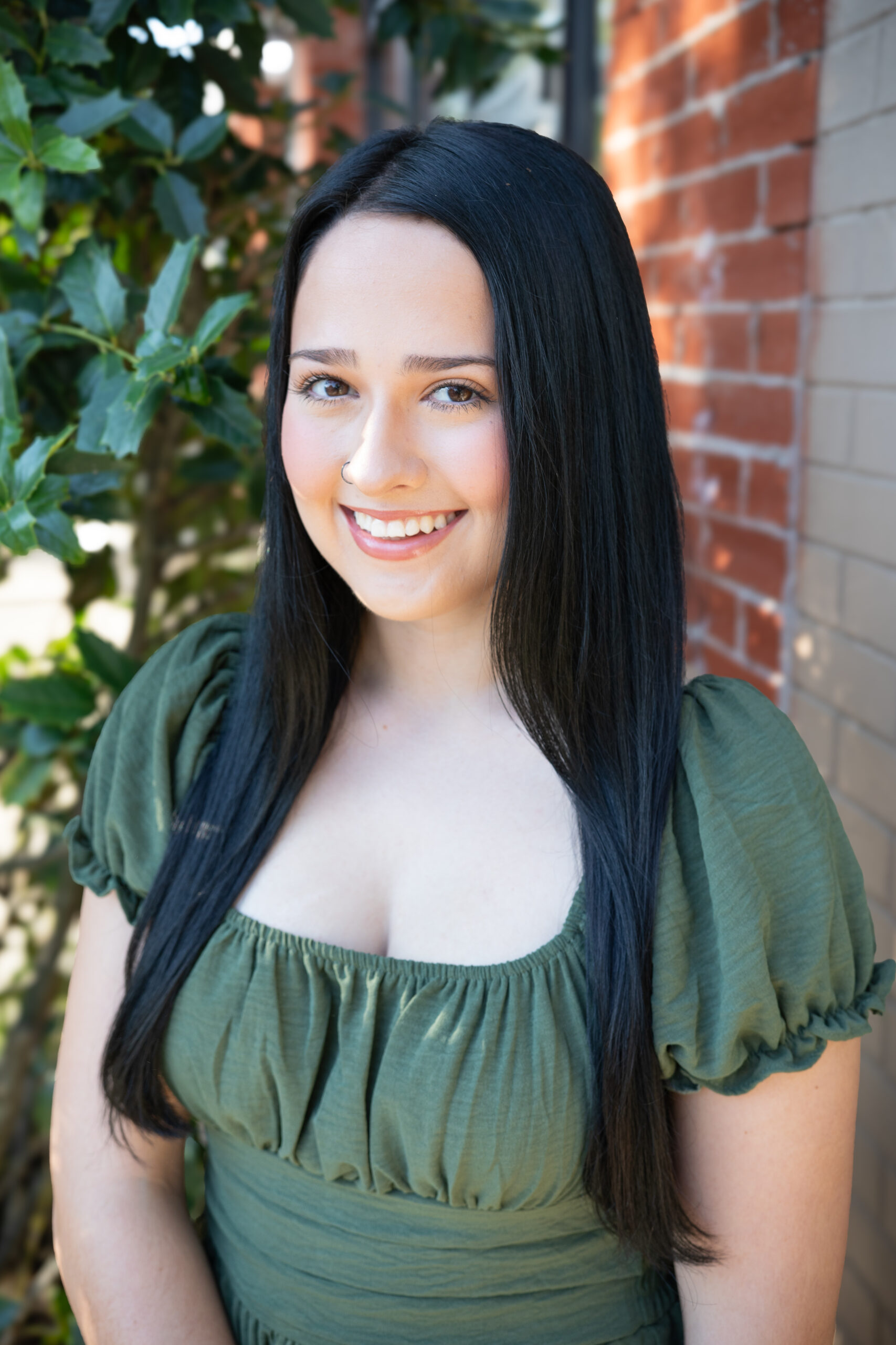 Visitors Center Coordinator Emma Bailey in front of Saltwater Fishery.