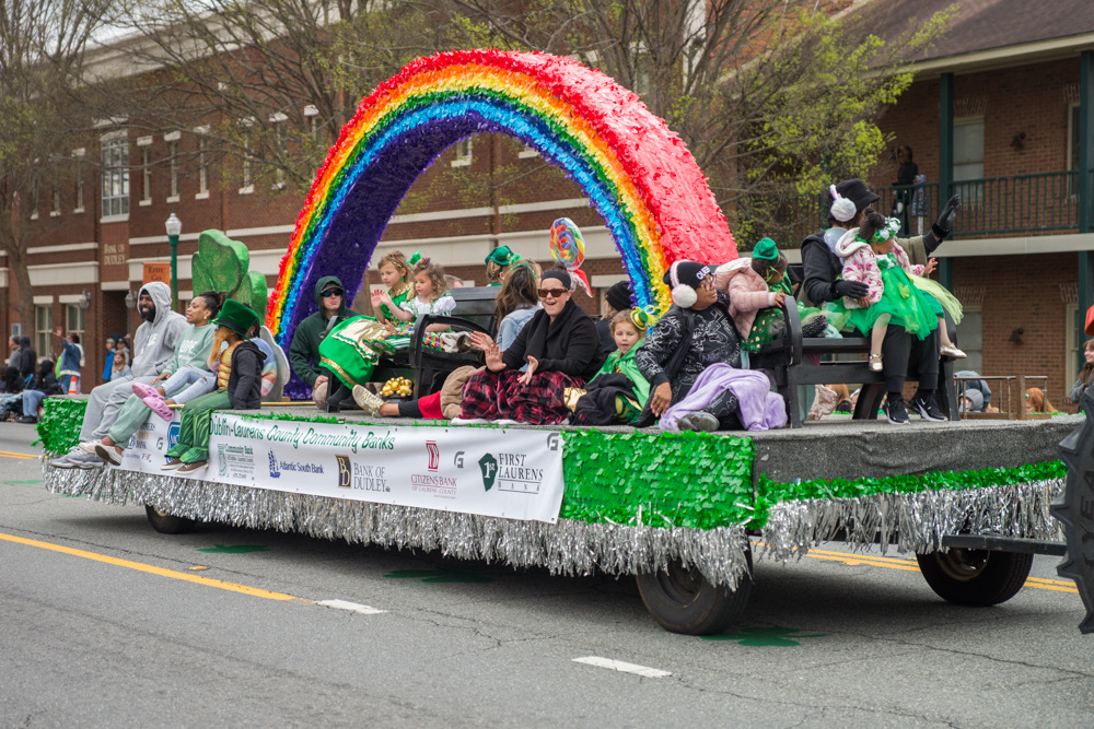 Children riding on a brightly colored float in St. Patrick's Parade. Tourism grant funding will assist in marketing support for the festival.