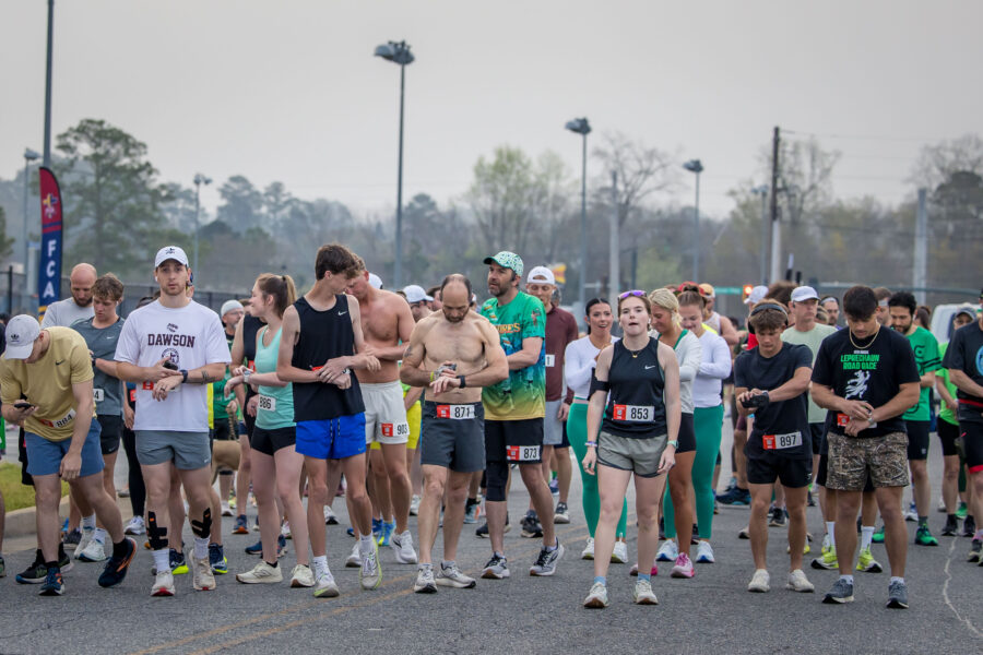 Huge group of runners in a crowd dotted in festive green, getting ready to take off at the start of the Leprechaun Road Race in Dublin, Georgia.