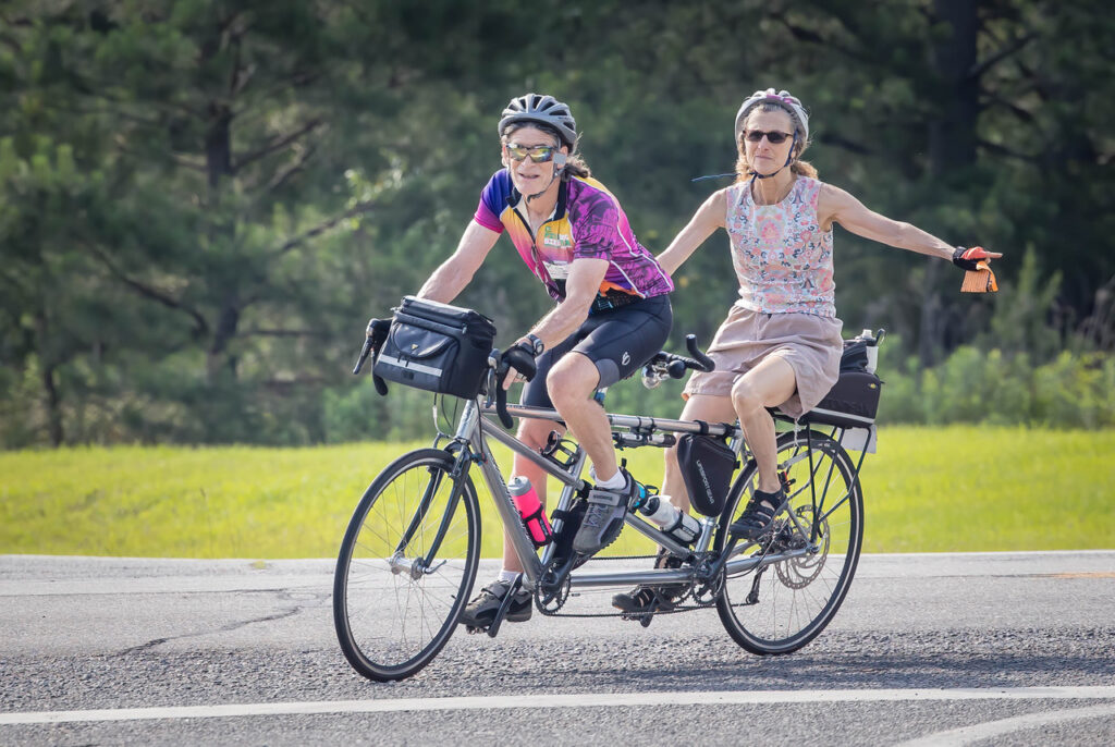Bicycle riders on a tandem bike that could participate in the Patriotic Parade!