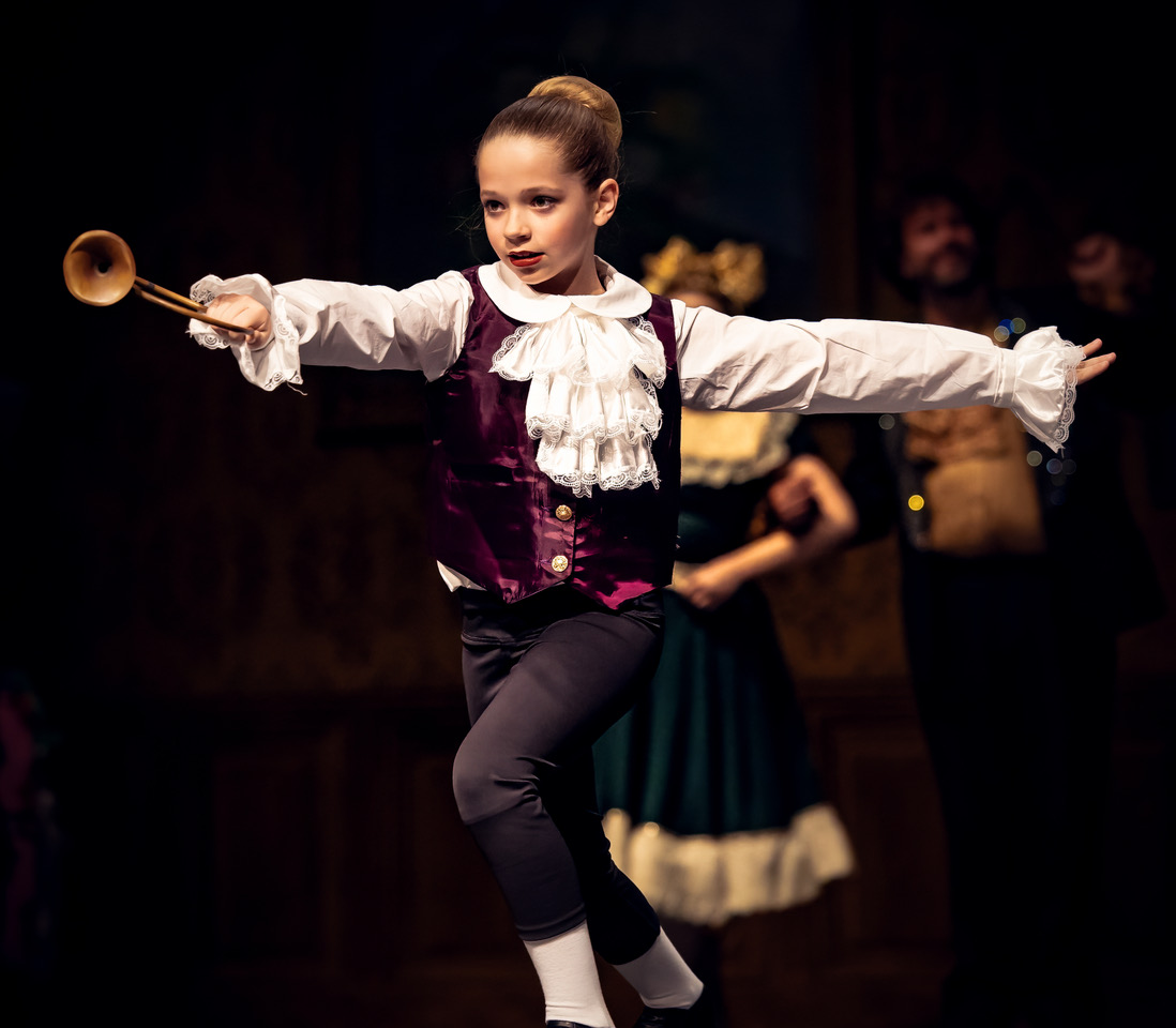 Dancer dressed as a "party boy" dancing a part on stage during a Christmas party scene in Dublin Nutcracker.