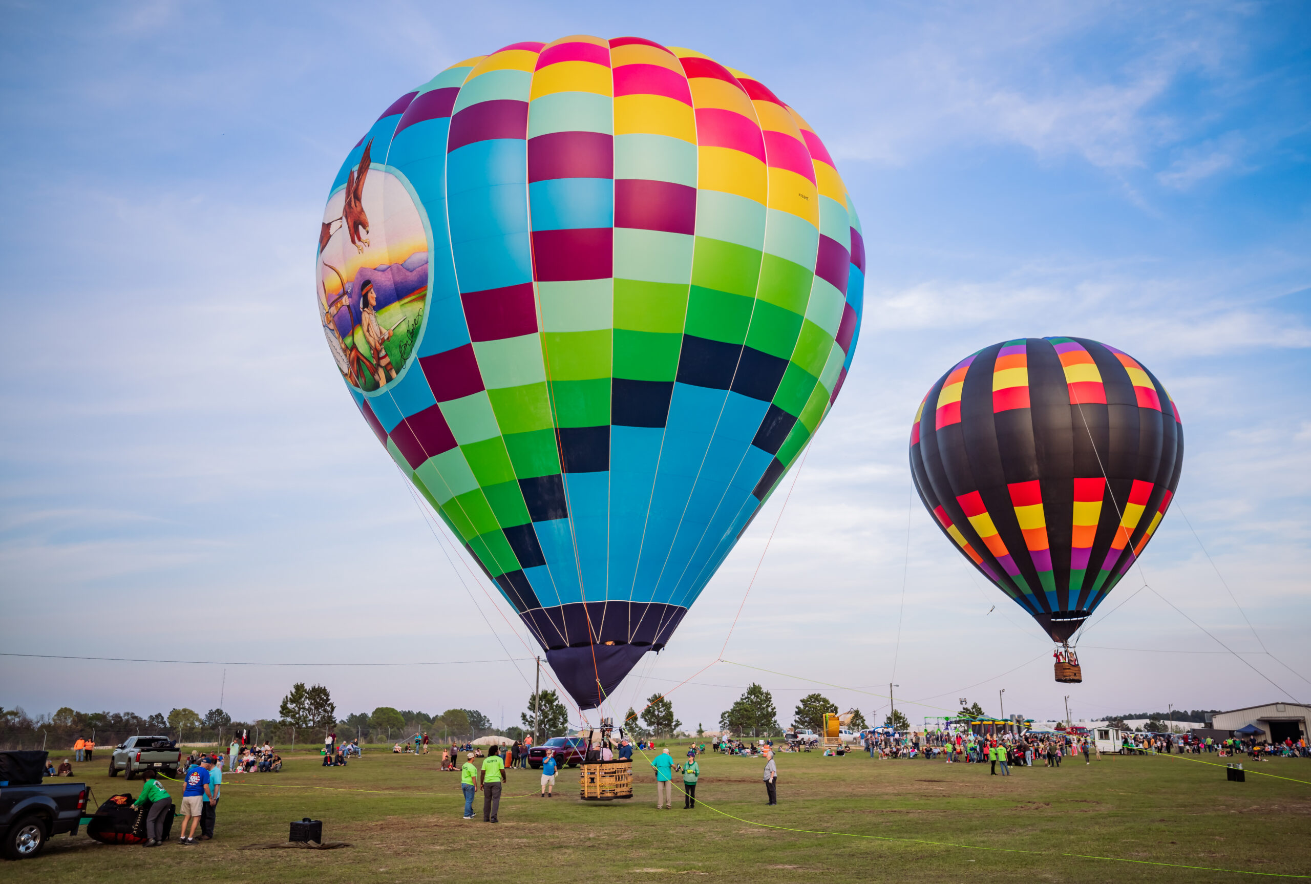 Colorful hot air balloons against a blue sky during Dublin's St. Patrick's hot air balloon festival.